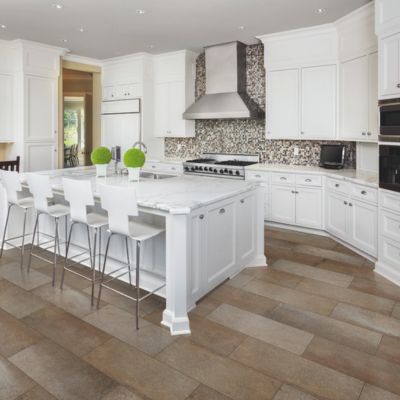 stone backsplash in a bright white kitchen